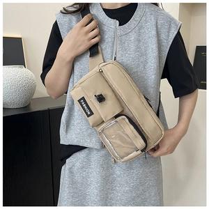 Macro detail of khaki crossbody bag featuring clear PVC compartment and fashion label
