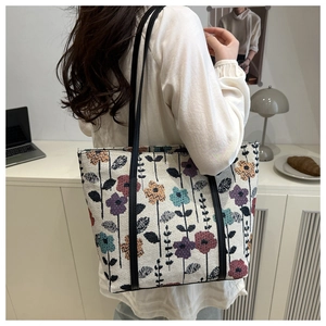 Detail of canvas tote bag with colorful floral pattern and slim shoulder straps
