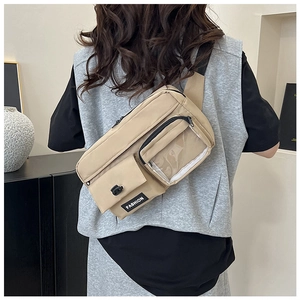 Detail view of khaki crossbody bag with multi-pocket design and transparent PVC window