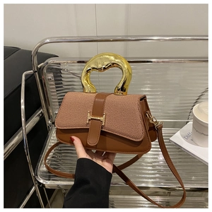 Detail of brown leather and woven texture mix bag with gold metal handle and H buckle