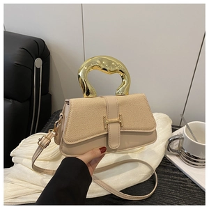 Close-up of beige woven texture and H-shaped gold buckle on a stylish box bag