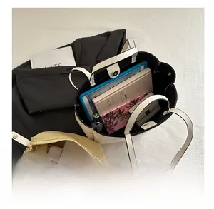 Spacious tote bag interior showing capacity for tablet, journals, and a small pouch