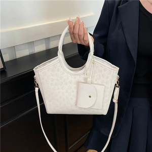 White tote bag with clover embossing, matching crossbody strap and small round pouch charm