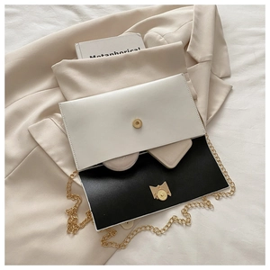 Detail of crossbody bag interior showing storage space for cosmetics and wallet