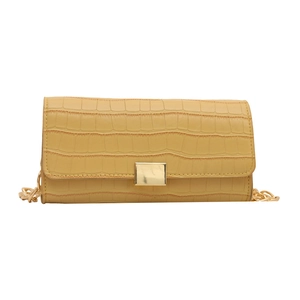 Yellow crocodile pattern baguette bag with a gold chain strap and metallic closure