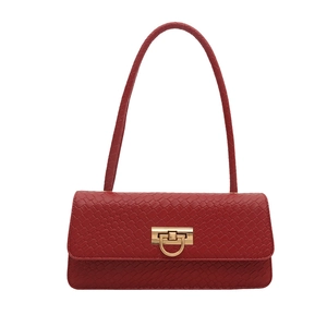 Red faux leather shoulder bag with woven texture and gold ring clasp on white background