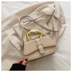 Close-up of cream leather bag featuring woven flap, H-buckle, and golden metal handle