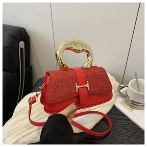 Detail view of red sequin evening bag with gold H-clasp and metallic top handle