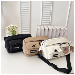 Detailed view of canvas shoulder bags in black, khaki, and beige with multiple pockets