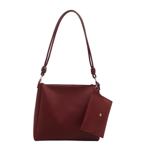 Deep red vintage tote bag set in premium faux leather with decorative knot shoulder strap
