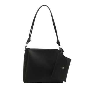 Minimalist black tote bag with matching pouch and knotted strap on white background
