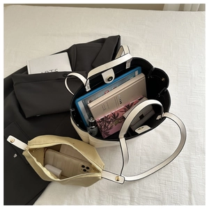White tote bag showing large capacity with inner yellow canvas pouch and daily items