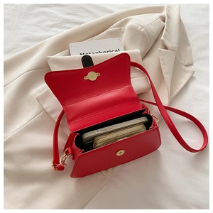 Interior view of the red crossbody bag showing capacity for a phone and small wallet