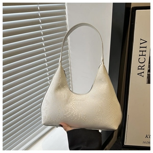 Detailed close-up of white semi-circle shoulder bag with snake skin texture and metal chain