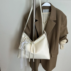 Chic cream large capacity tote bag with pearl bow pendant and minimalist leather finish