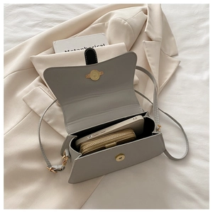Interior view of small sage green crossbody bag showing space for phone and wallet