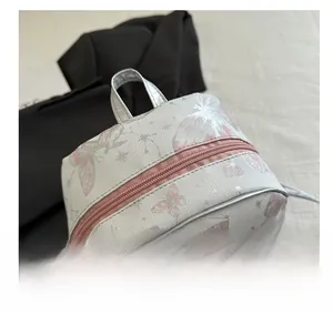 Detail view of woven backpack with pink butterfly prints and durable metal zipper