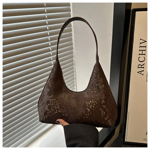 Macro detail of dark brown python-textured shoulder bag with smooth zipper closure