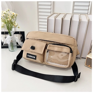 Detail of khaki crossbody bag featuring multiple front pockets and adjustable black strap
