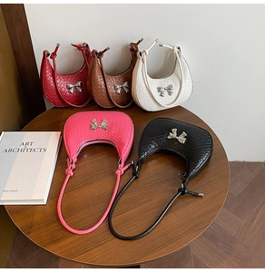 Collection of woven hobo bags with metal bow details in red, brown, white, pink and black