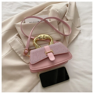 Close-up of pink tweed shoulder bag with gold metal handle and H buckle detail