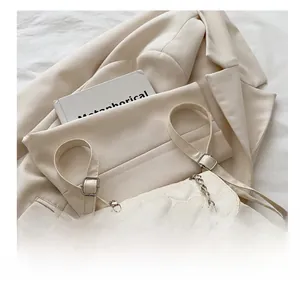 Close-up of cream white heart-quilted backpack with silver chain and leather straps