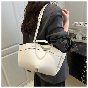 Model view of cream leather tote bag with black edge painting in a modern home setting