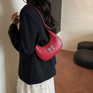 Red woven hobo bag with silver bow accent and slim shoulder strap for women