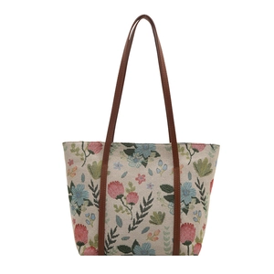 Floral canvas tote bag with retro floral print and brown leather shoulder straps