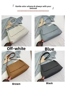 Detail of four woven shoulder bags in white, blue, brown, and black with metal chains