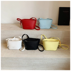 Detailed view of five mini bucket bags in lychee texture on concrete stairs