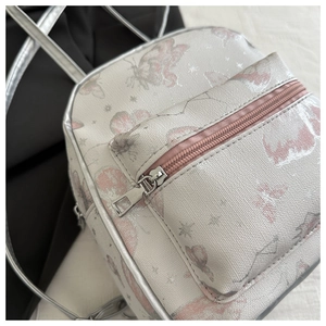 Detail of cross-textured PU leather backpack with butterfly print and silver piping