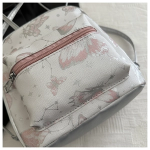 Detailed macro view of white PU leather bag featuring pink butterfly and star patterns