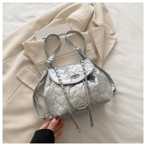 Detail of silver heart-quilted backpack with metal chain strap and twist lock