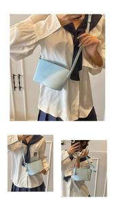 Detail of light blue lychee pattern bucket bag with Fashion & Bags embossed logo