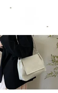 Detail of off-white tote bag with woven diagonal texture and silver chain strap