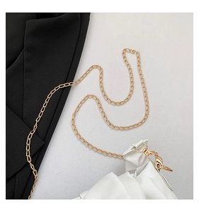 Detail of white pleated dumpling bag with elegant gold chain strap and metal buckle