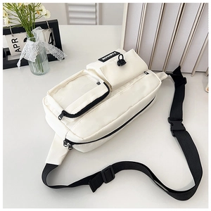 Detailed close-up of white multi-pocket chest bag with clear slot and black fashion label