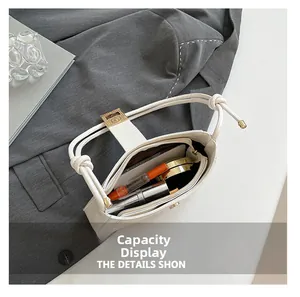 Interior view of white shoulder bag showing capacity for phone and cosmetics