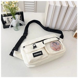 Detail of white crossbody bag with black buckle strap and transparent window for pins