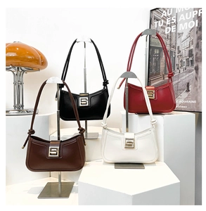 Detail view of colorful minimalist hobo bags with metallic S buckles and knotted handles