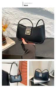 Detail of a black leather underarm bag with a geometric square metallic clasp for women