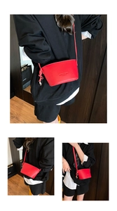Detail of red lychee textured bucket bag with embossed Fashion & Bags lettering