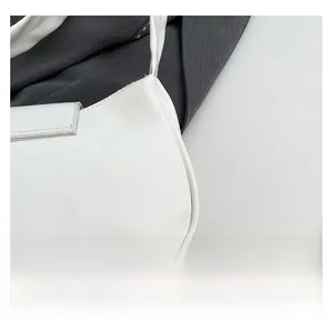 Detail shot of smooth white PU leather texture and neat stitching on shoulder bag
