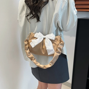 Chic khaki pleated underarm bag with oversized white satin bow and metal chain strap