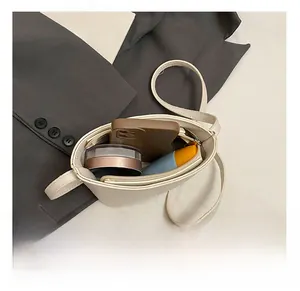 Top view showing interior capacity for smartphone, makeup, and cream in a small crossbody bag