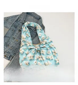 Detail of light blue floral tote bag featuring white 3D flowers and a stylish bow knot