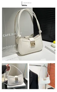 Detail of white minimalist shoulder bag with geometric gold buckle and knotted straps