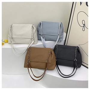 Close-up of four colors of twill texture crossbody bags with metal chain straps