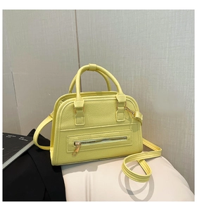 Detail of lemon yellow pebble leather texture on this trendy Boston crossbody handbag